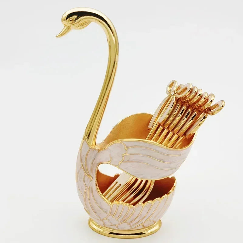 Gold and white enamel swan-shaped decorative holder with gold utensils inside