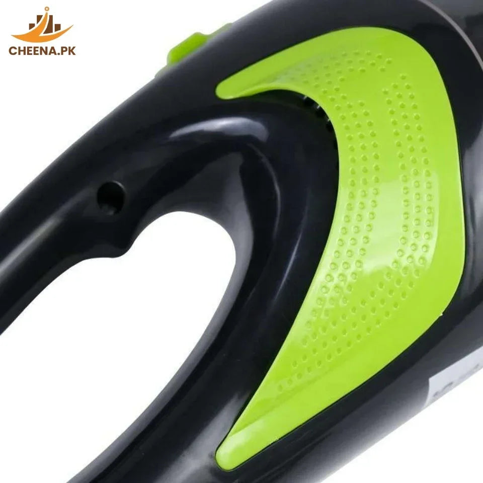 Close-up of black and green ergonomic handheld vacuum cleaner handle with textured grip