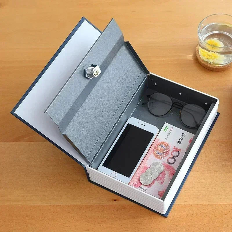 Opened hollow book safe on wooden table holding smartphone, Chinese yuan cash, coins, and eyeglasses