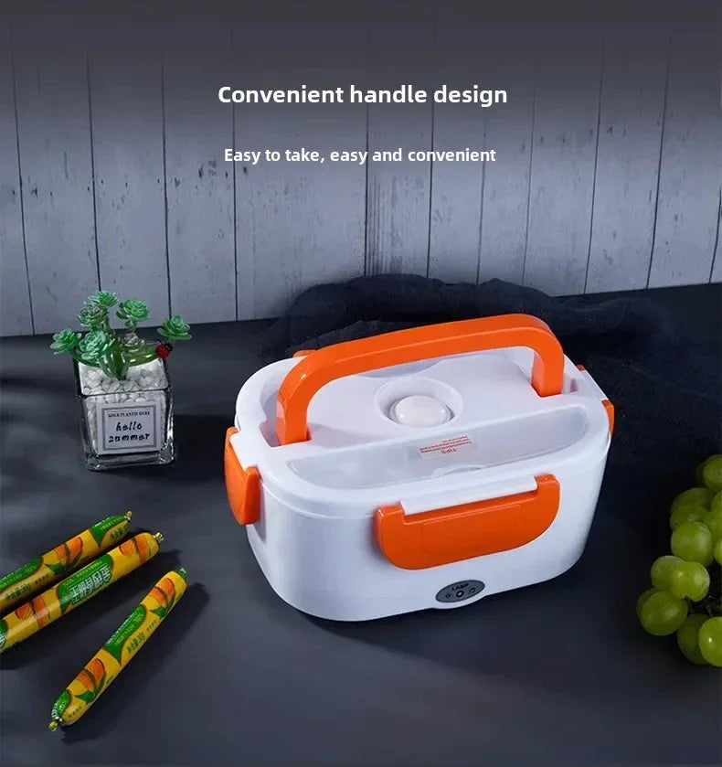 Portable electric lunch box with orange handle and clips on gray surface with grapes and snacks