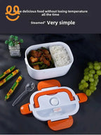 White and orange lunch box with steamed rice and meat with green beans, plastic spoon, green grapes, and decorative plant