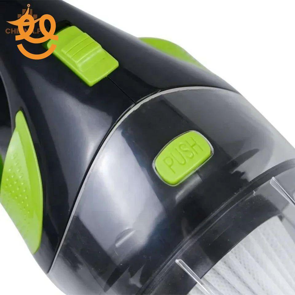 Close-up of black and green handheld vacuum cleaner with push button and brand logo