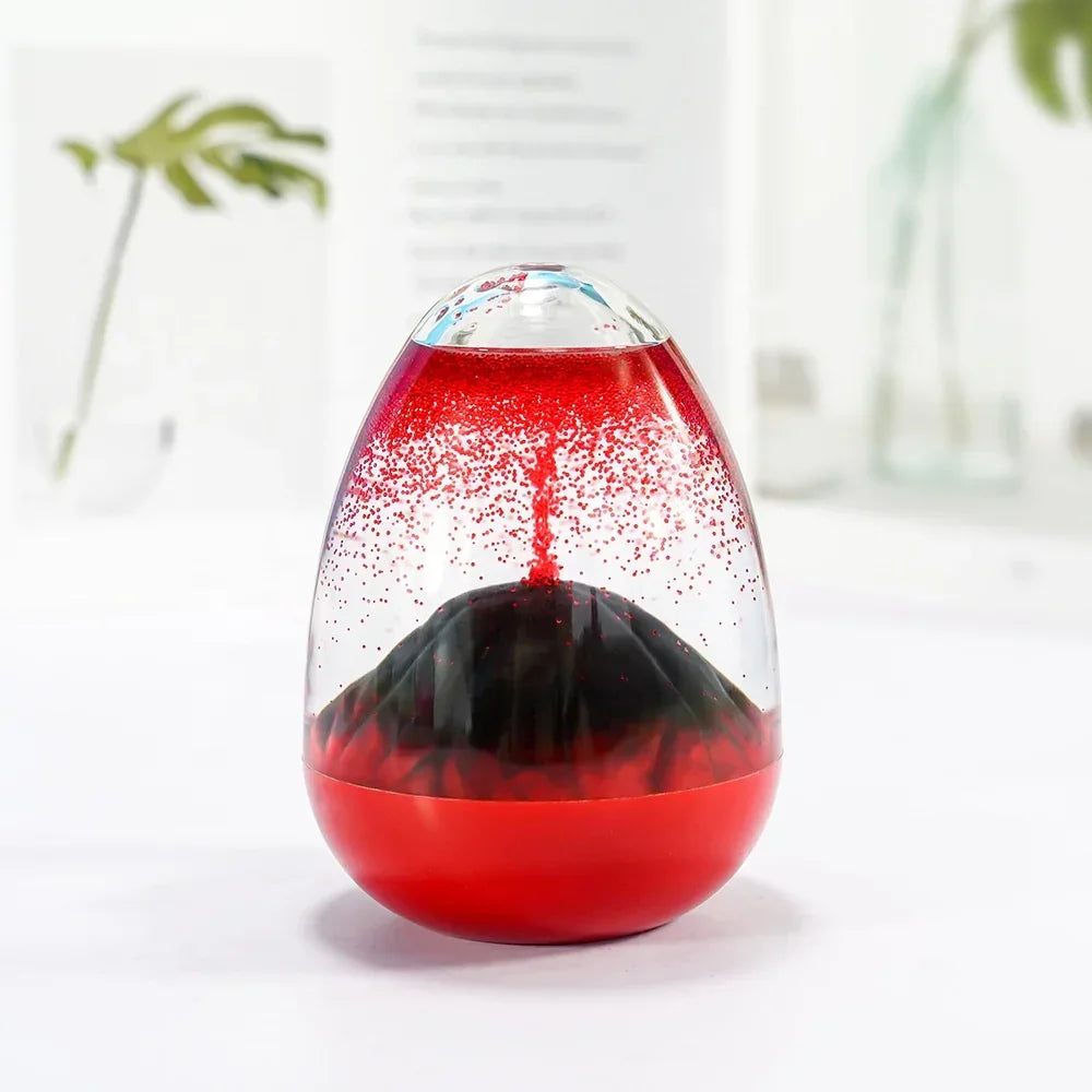 Red lava lamp with black base on white table, blurred green plant and bottles in background