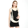 Pregnant woman wearing black dress and beige maternity belly support belt with adjustable straps