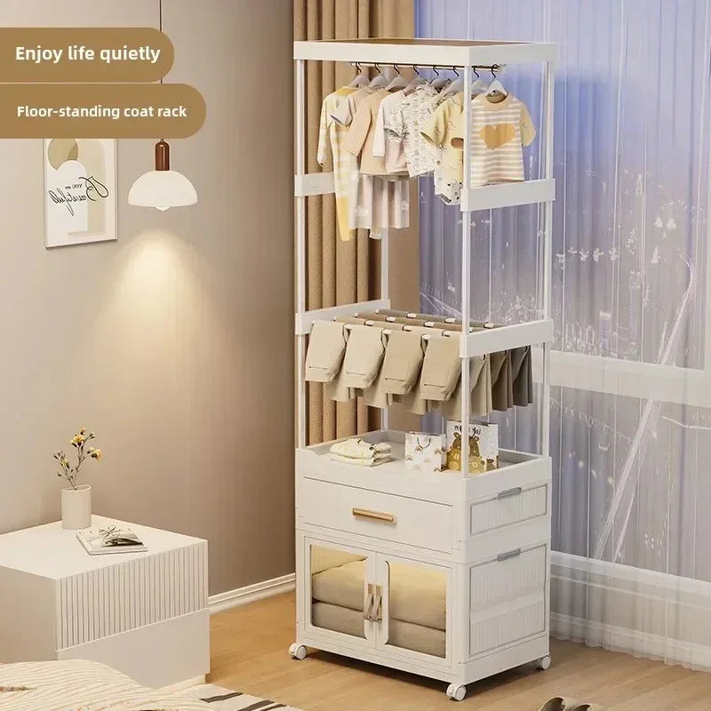 White floor-standing coat rack with hanging clothes and folded pants in a modern bedroom setting