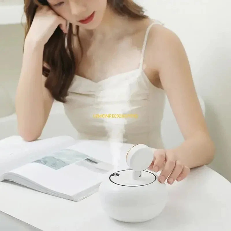 Woman in white dress using white portable humidifier on white table while reading magazine