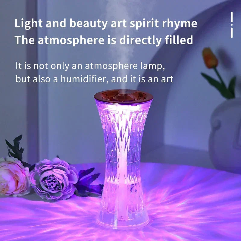 Purple LED atmosphere humidifier lamp on table with decorative flowers and soft lighting