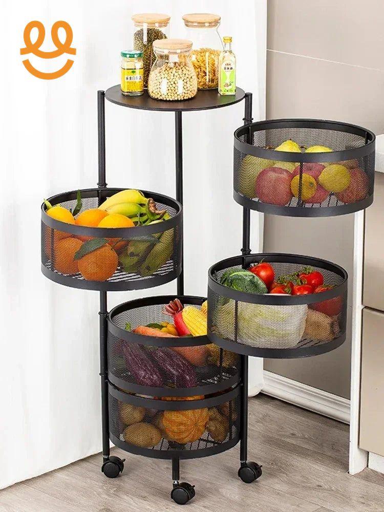 Black metal mesh tiered kitchen storage cart with fresh fruits, vegetables, and glass jars on wheels