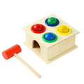Wooden pounding bench toy with colorful balls and red mallet for toddler play