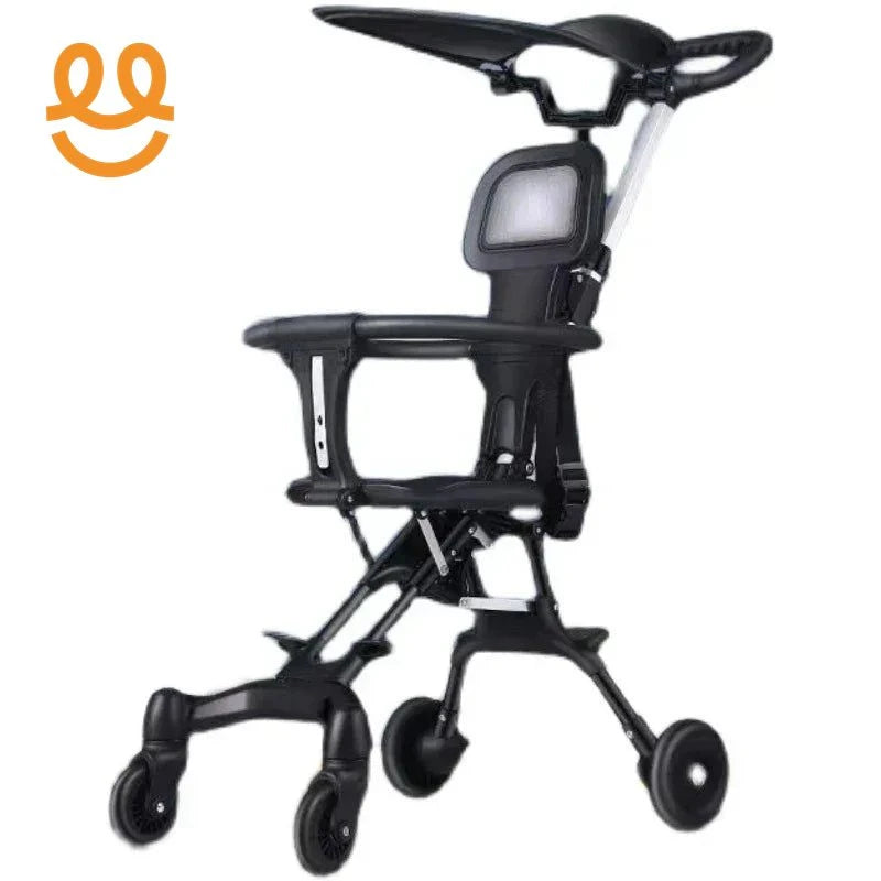 Compact black baby stroller with canopy, safety harness, and four wheels on white background