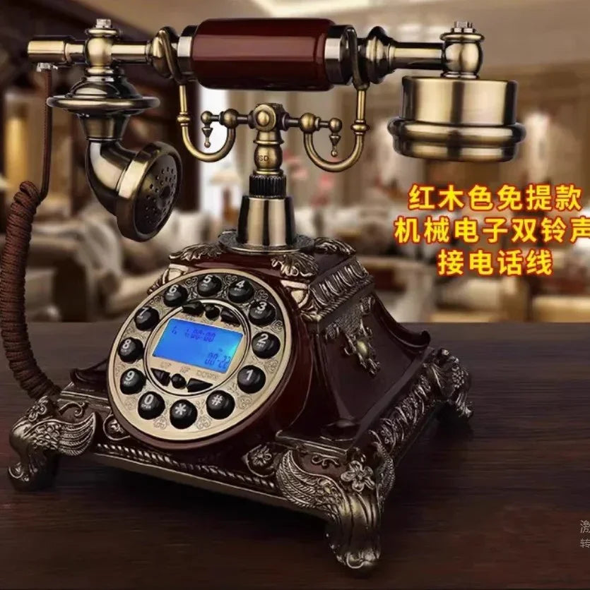 Vintage rotary dial telephone with ornate bronze and wood design on a wooden table