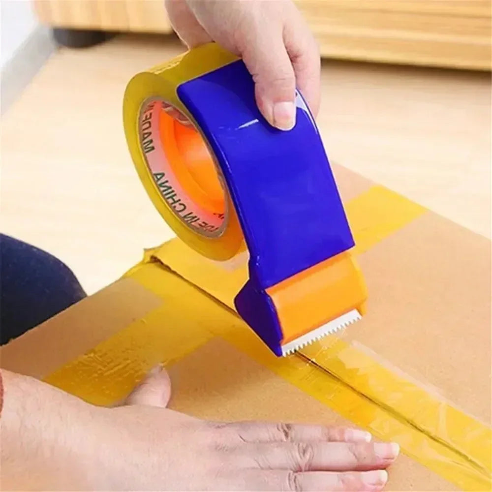 Hand using blue and orange tape dispenser to seal cardboard box with yellow packing tape