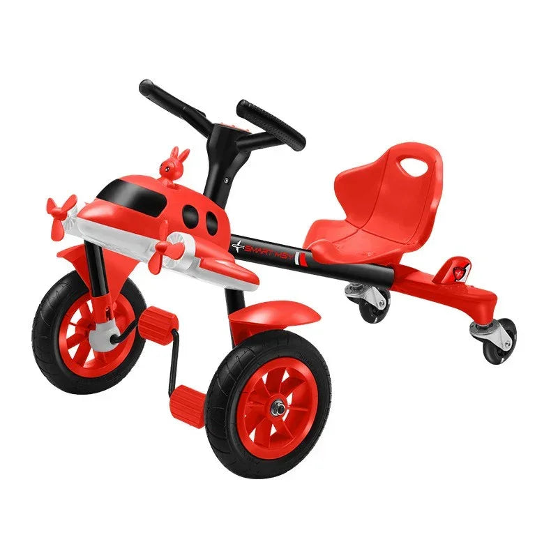 Red and black kids' ride-on tricycle with airplane wings, pedals, and a comfortable seat