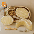 Natural bath accessories including loofah sponges, wooden comb, and pumice stone on beige bathroom counter