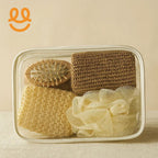 Clear pouch containing brown and beige knit washcloths, wooden hairbrush, and cream bath sponge