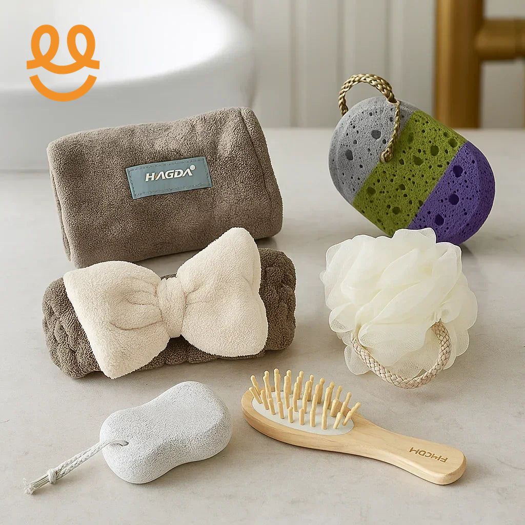 Set of bathroom essentials including brown towels, pumice stones, a bath sponge, and a wooden hairbrush on a white surface