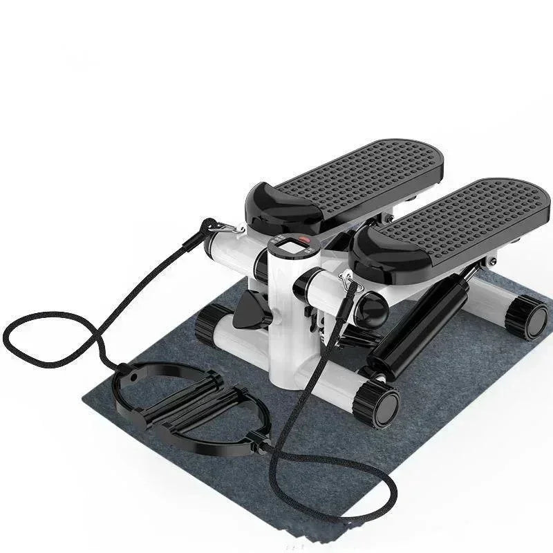 Compact black and white mini stepper with resistance bands on a gray mat for home workout