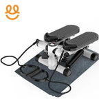 Compact black and white mini stepper with resistance bands on a gray mat for home workout