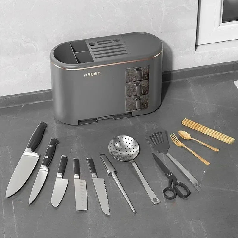 Gray Ascor kitchen knife holder with knives, kitchen tools, wooden cutlery, and chopsticks on gray countertop