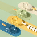 Colorful plastic dumpling makers in blue, yellow, green, and white with patterned handles on striped background with dumplings