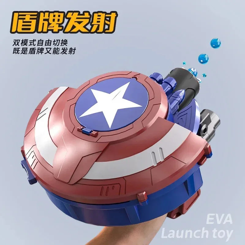 Red, white, and blue shield-shaped water launch toy with a white star, held in hand, shooting water droplets