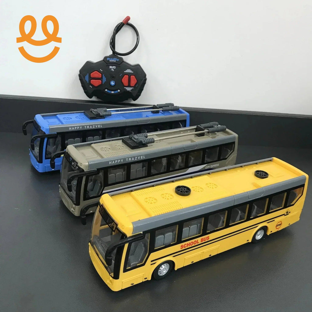 Three remote control toy buses in yellow, beige, and blue with a black and red remote on a gray surface
