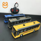 Three remote control toy buses in yellow, beige, and blue with a black and red remote on a gray surface