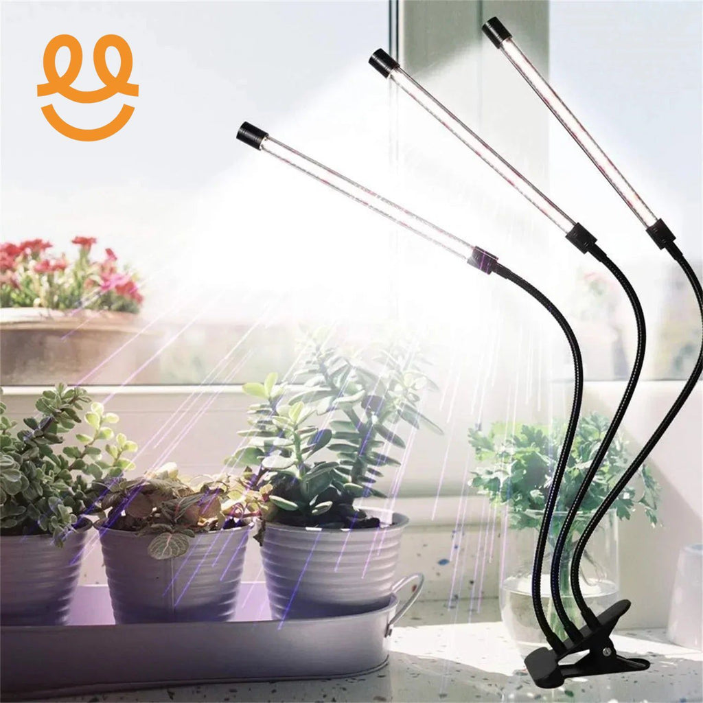 Indoor plants on windowsill lit by three flexible LED grow lights with clip base
