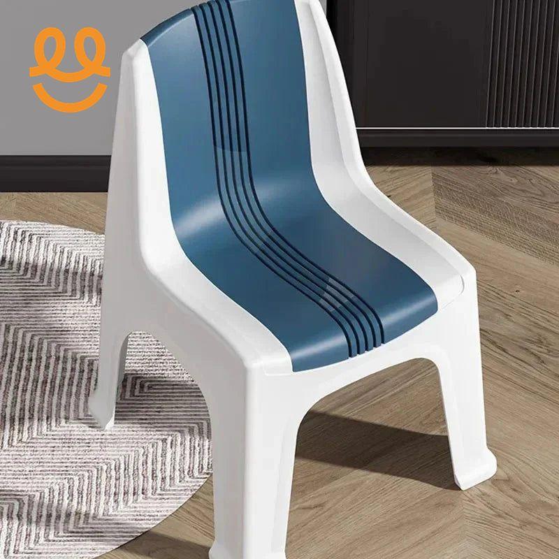 Modern white plastic chair with blue striped seat on wooden floor next to gray patterned rug