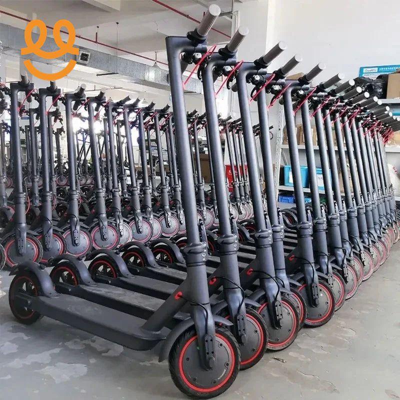 Rows of black electric scooters with red accents lined up indoors in a warehouse setting