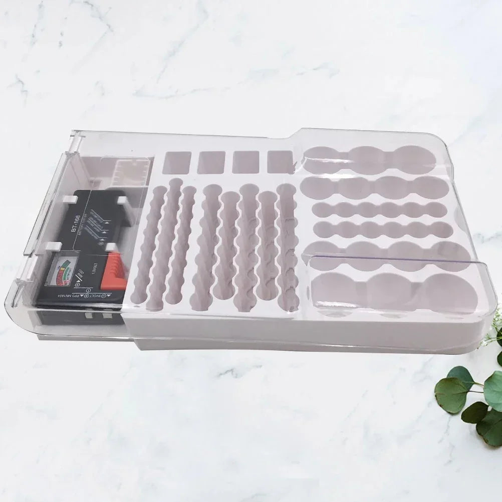 Transparent storage box with organized compartments and a small black electronic device inside