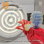 Red and gold electric water bomb launcher toy shooting water bubbles at circular target indoors
