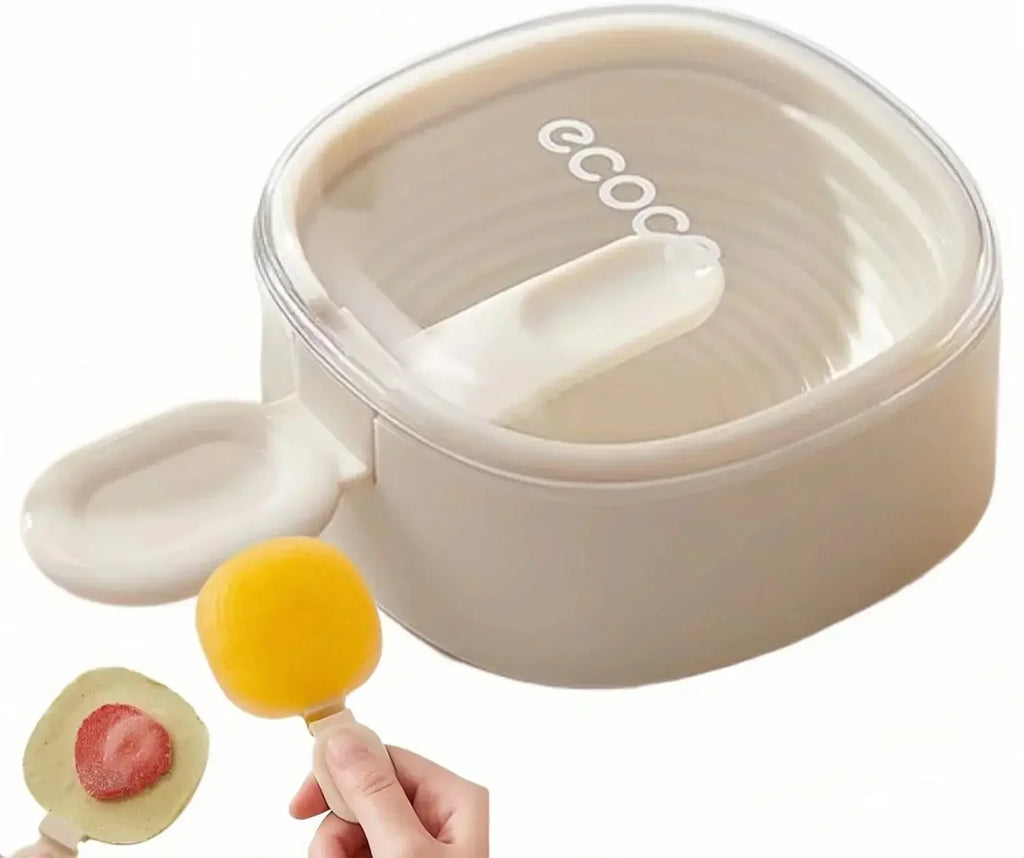 Beige Ecooe fruit popsicle mold with removable lid and two frozen treats, one with strawberry