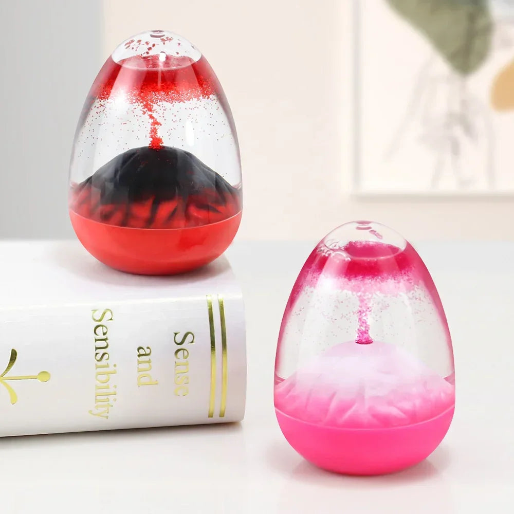 Two colorful egg-shaped lava lamps with red and pink liquid on a white table, one on a book titled Sense and Sensibility