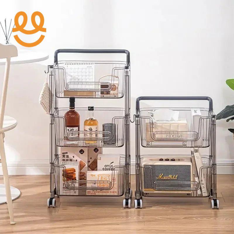 Two transparent rolling storage carts with snacks, bottles, tissue box, and decorations on wooden floor