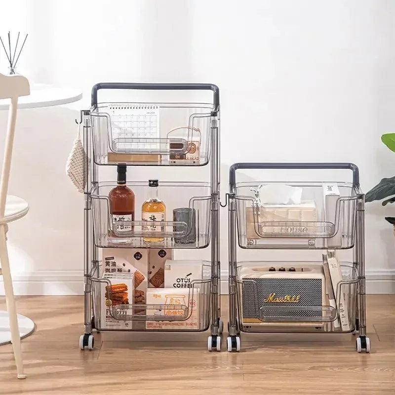 Two transparent rolling storage carts with snacks, bottles, tissue box, and decorations on wooden floor