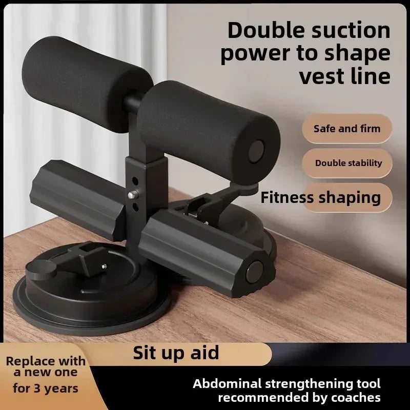 Black sit-up aid with double suction base and foam padding on wooden surface for abdominal fitness shaping