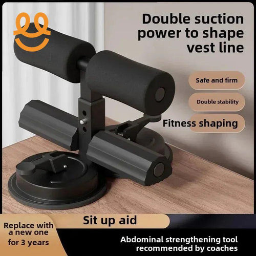 Black sit-up aid with double suction base and foam padding on wooden surface for abdominal fitness shaping