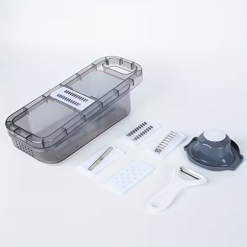 Gray plastic vegetable slicer set with multiple blades, peeler, and safety holder on white background