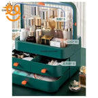 green cosmetic organizer with clear lid holding skincare bottles, lipsticks, brushes, and drawers with makeup items