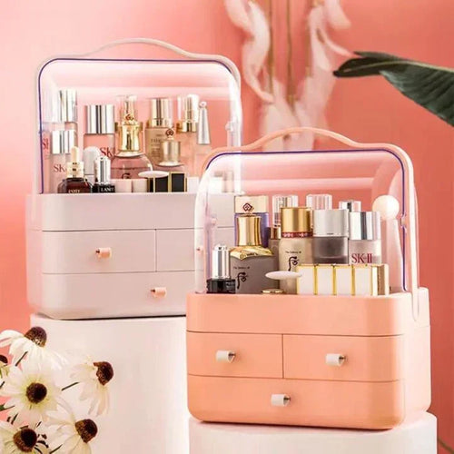 Two pink and peach cosmetic storage organizers with clear tops holding skincare and beauty products on white pedestals