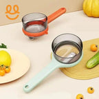 Two transparent measuring cups with pastel handles on kitchen counter, surrounded by cherry tomatoes, lemon, and cucumber