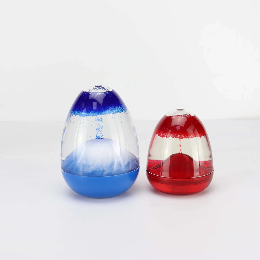Two egg-shaped decorative objects with suspended blue and red particles in clear liquid