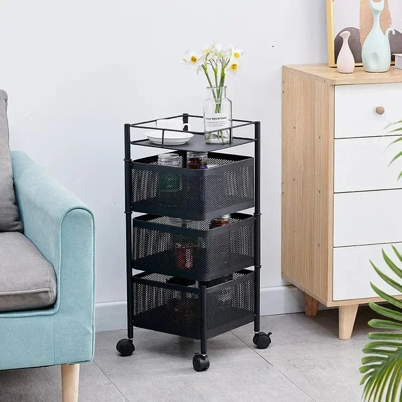 Black metal mesh rolling storage cart with three baskets, placed between light blue sofa and wooden cabinet