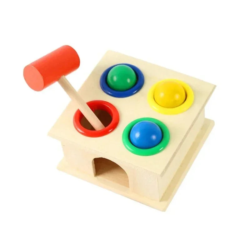 Wooden hammer toy with red mallet and colorful balls in red, blue, green, and yellow holes