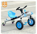 Blue and white kids tricycle with airplane design and light-up rear caster wheels on pavement