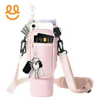 Pink crossbody bag with pockets holding credit card, phone, cash, keys, and car key fobs