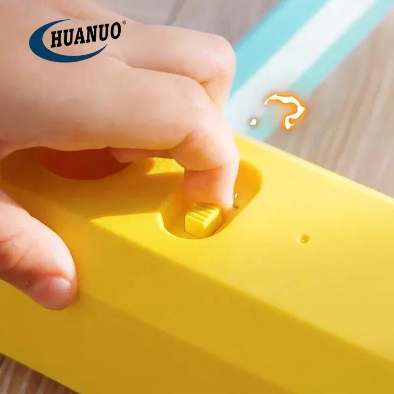Hand pressing yellow switch on HUANUO yellow device on wooden surface