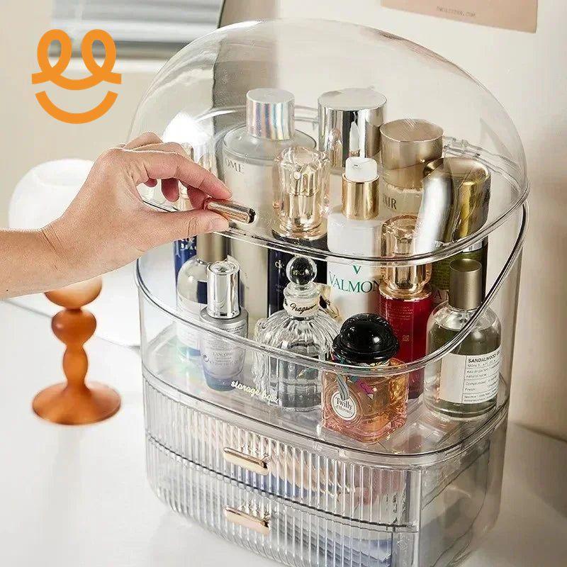 Clear acrylic cosmetic organizer with various perfume bottles and skincare products inside on white surface
