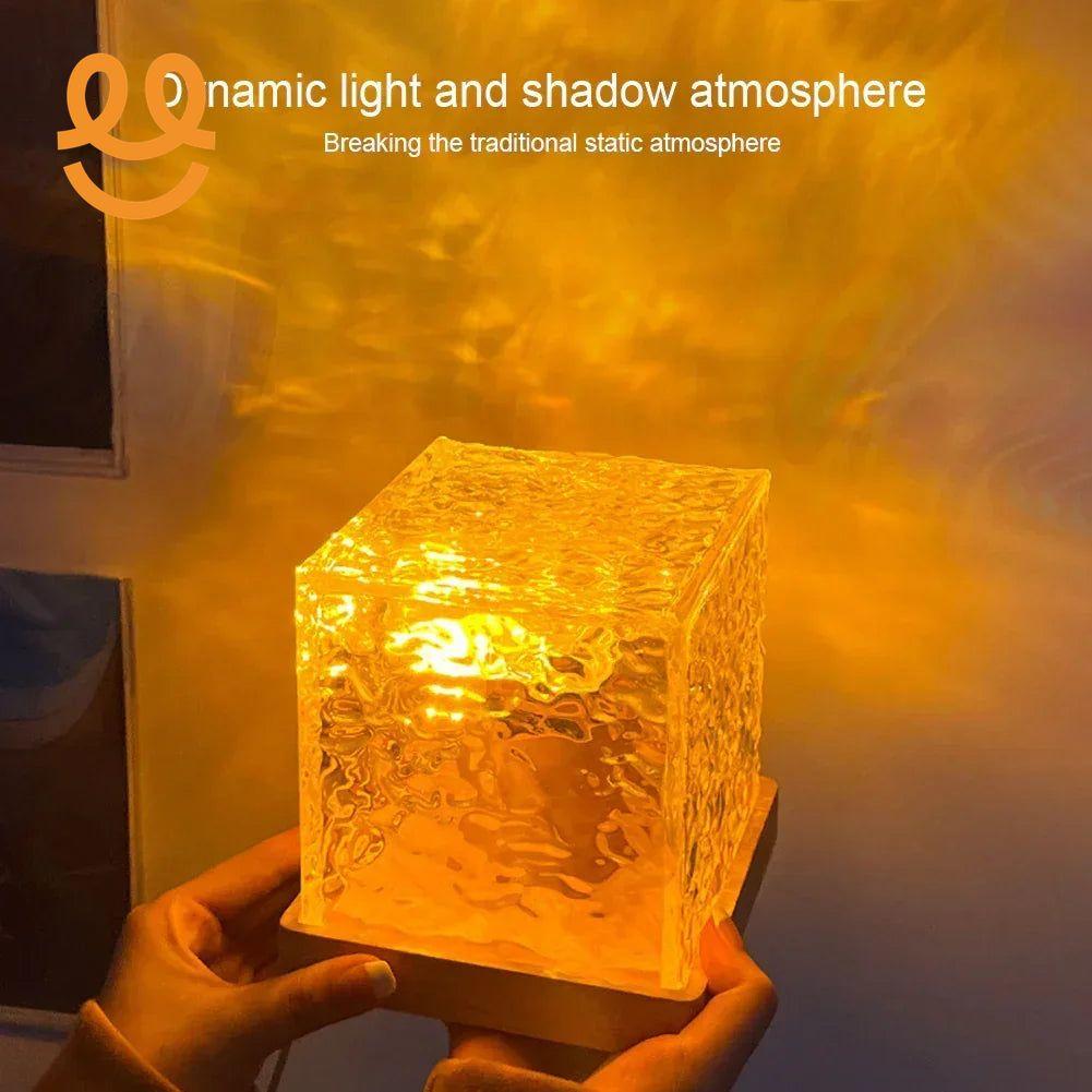 Person holding a glowing textured glass cube lamp creating a dynamic warm light and shadow atmosphere